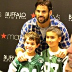 Eric Decker at the Macy's Mens Style Event taking pictures with children