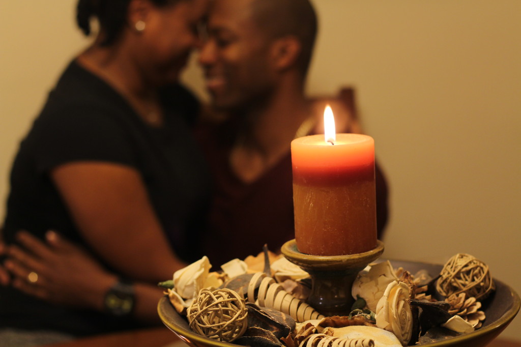 husband and wife hugging by candlelight