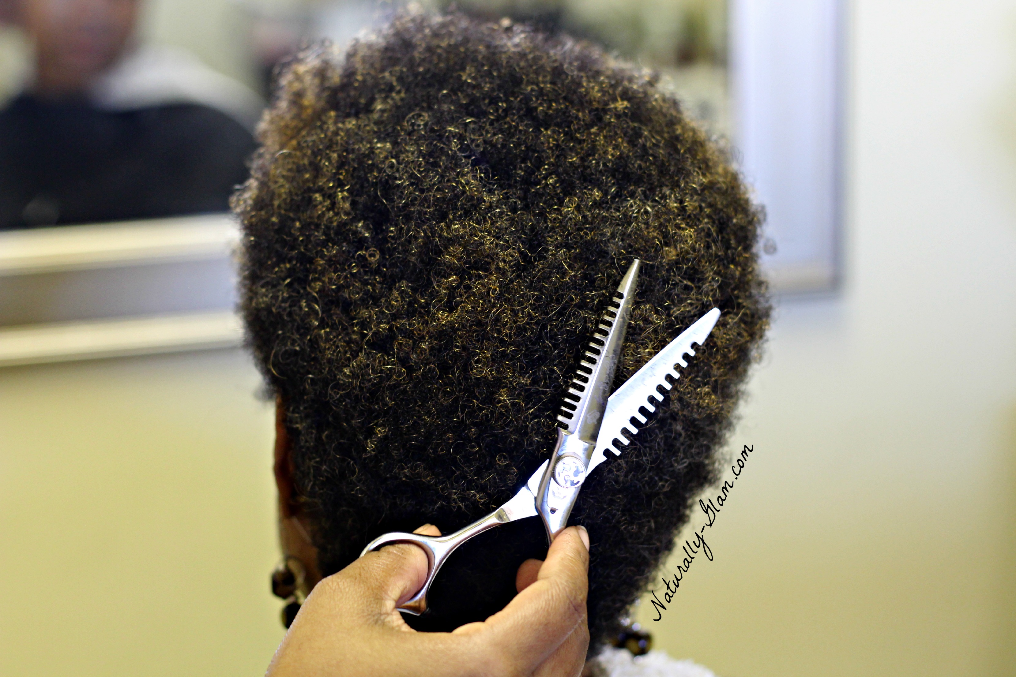 kinky 4c natural hair getting cut by hair stylist
