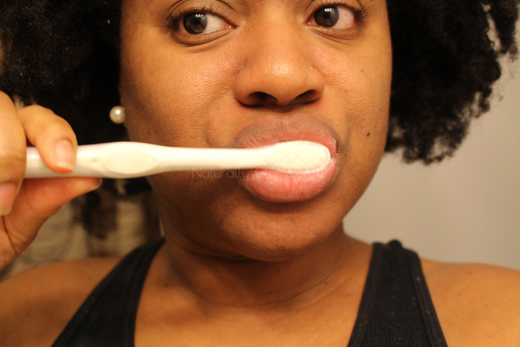 brushing my teeth using colgate optic white express white toothpaste