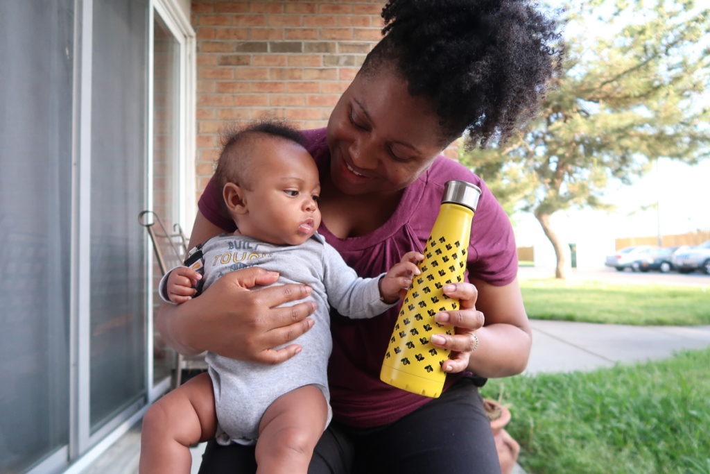 Moms Drink More Water | Mom holding a baby and a water bottle