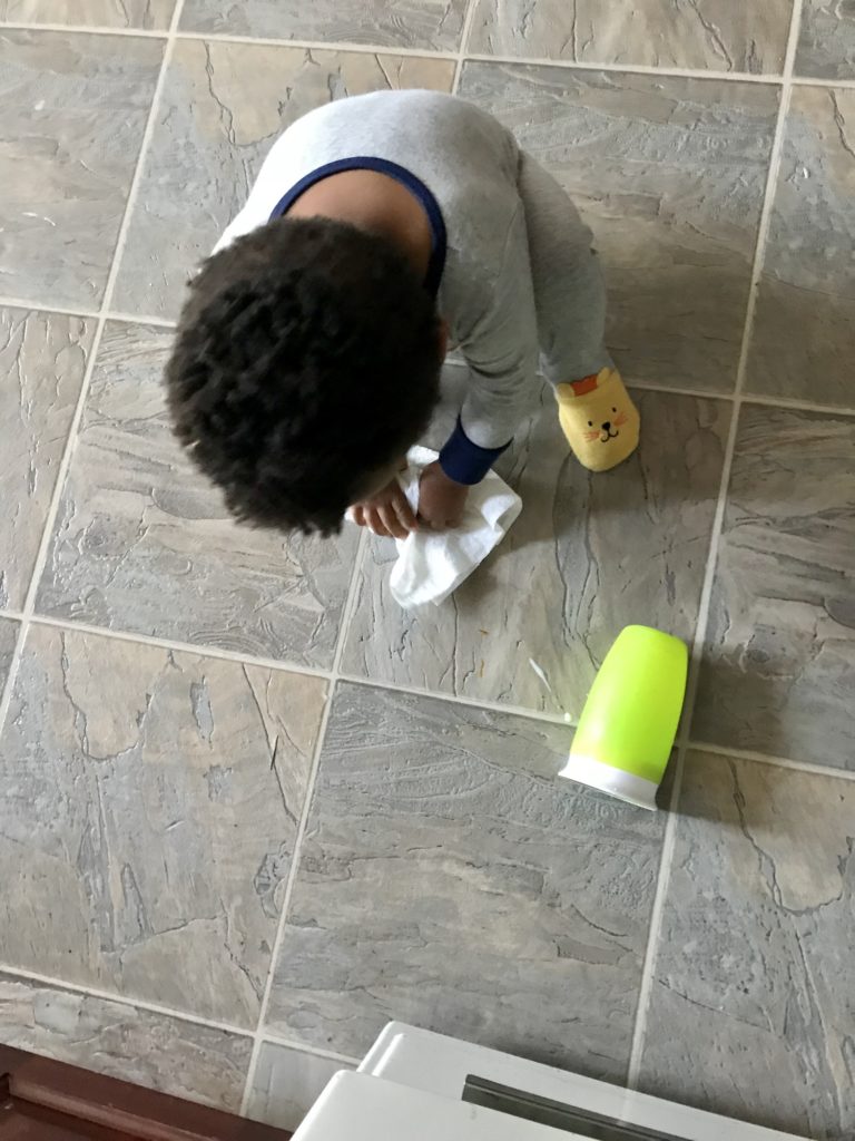morning routine, toddler cleaning up milk spill