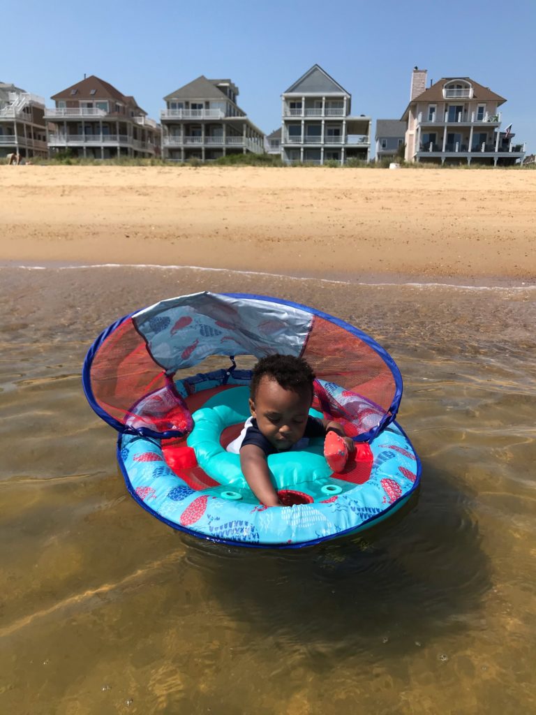 toddler in activity float at the beach, toddler summer essentials